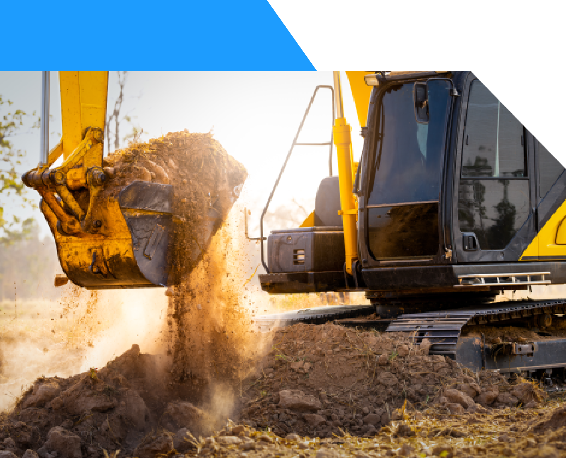 Excavator dumping soil at a construction site during sunset.